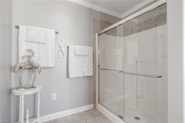 full bathroom with ornamental molding, tile patterned flooring, a shower stall, and baseboards