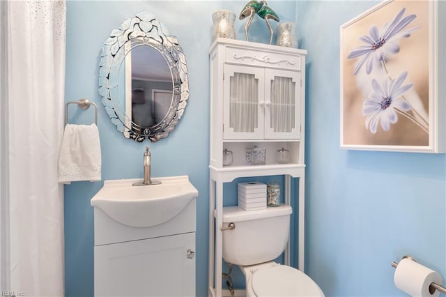 bathroom featuring vanity and toilet