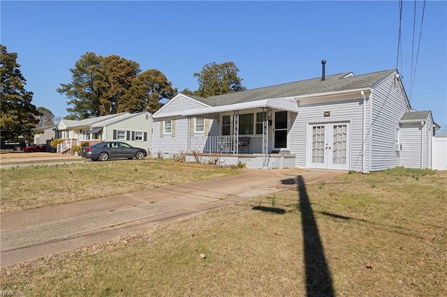 single story home with a front lawn and french doors