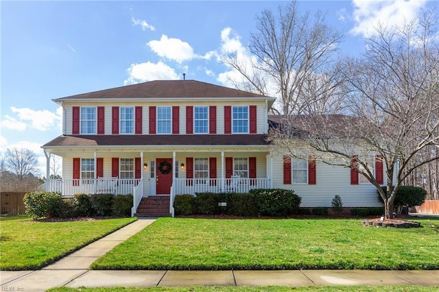 colonial house with covered porch and a front yard