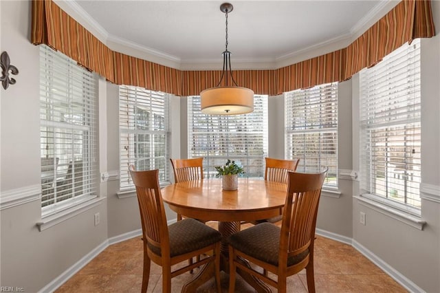 dining area with ornamental molding, tile patterned floors, and baseboards