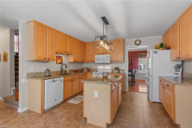 kitchen featuring white appliances, a kitchen island, a sink, and light stone counters