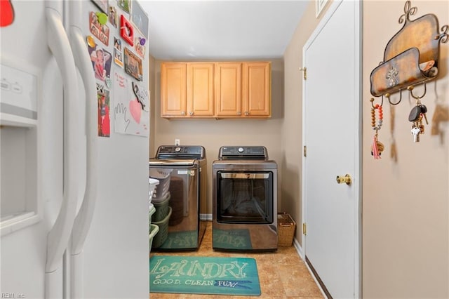 laundry room featuring cabinet space, independent washer and dryer, and baseboards