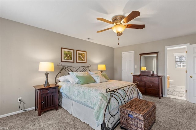 bedroom featuring baseboards, connected bathroom, visible vents, and light colored carpet