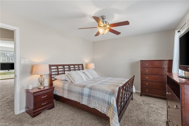 bedroom featuring carpet floors, a ceiling fan, and baseboards