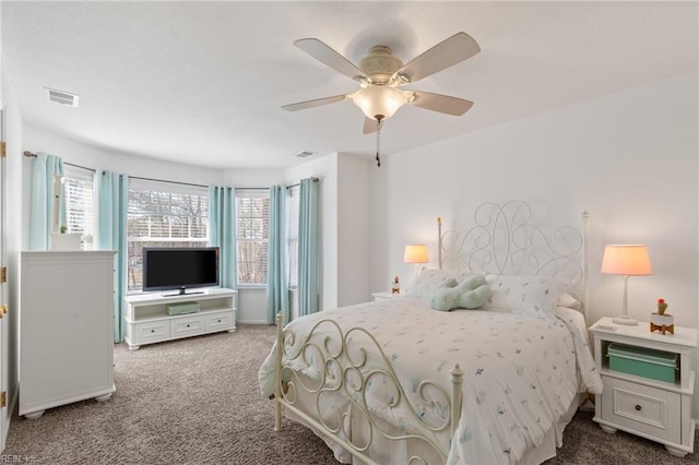 bedroom featuring a ceiling fan, visible vents, and carpet flooring