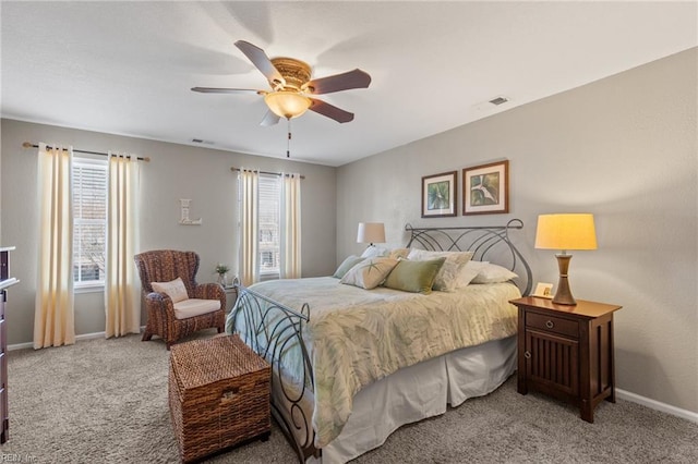 bedroom featuring multiple windows, visible vents, and carpet flooring