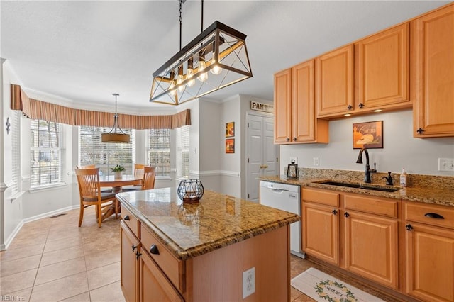 kitchen with light tile patterned floors, light stone counters, a sink, a center island, and dishwasher