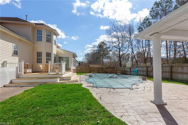 view of pool with a fenced in pool, a lawn, a patio area, a deck, and a fenced backyard