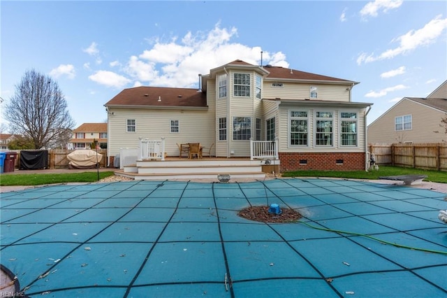 back of property featuring a fenced in pool, crawl space, a fenced backyard, and a deck