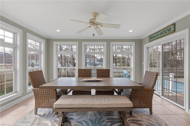 sunroom featuring plenty of natural light and a ceiling fan