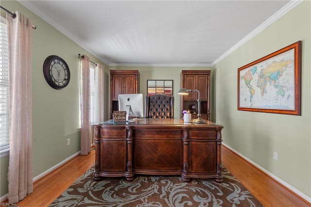 office featuring ornamental molding, light wood-type flooring, and baseboards