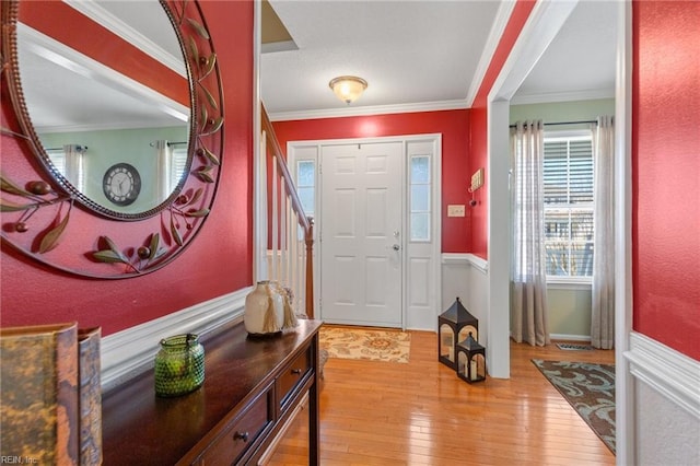 foyer entrance featuring hardwood / wood-style flooring and ornamental molding