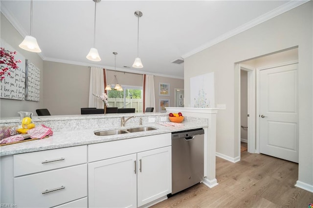 kitchen with white cabinets, ornamental molding, stainless steel dishwasher, light wood-style floors, and a sink