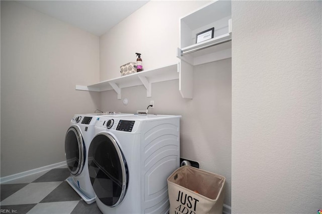 washroom with baseboards, laundry area, tile patterned floors, and washer and dryer