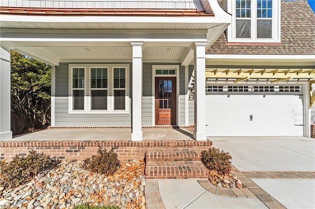 property entrance with a shingled roof, covered porch, driveway, and a garage