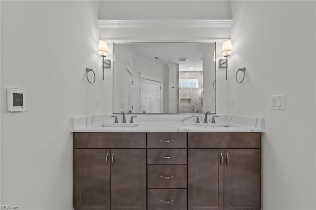 bathroom featuring double vanity, ornamental molding, and a sink