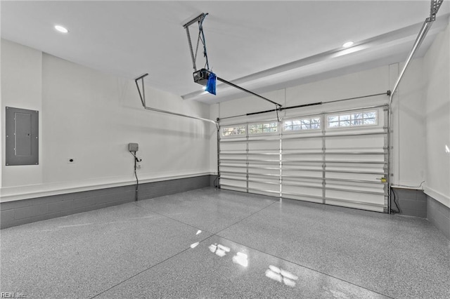 garage featuring recessed lighting, electric panel, and a garage door opener