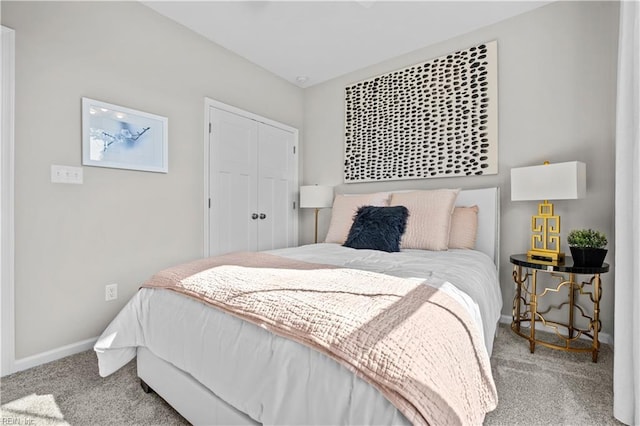 bedroom featuring a closet, carpet, and baseboards