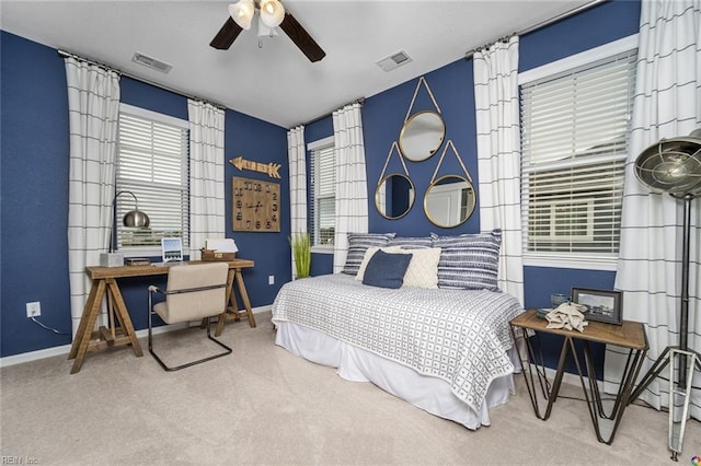 carpeted bedroom with a ceiling fan, visible vents, and baseboards