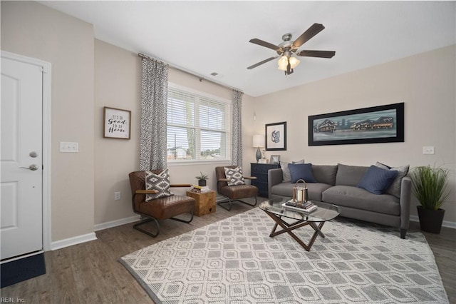 living room featuring ceiling fan, wood finished floors, and baseboards