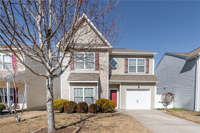 view of front of house featuring an attached garage, a shingled roof, concrete driveway, and brick siding