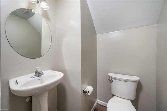 bathroom with baseboards and toilet