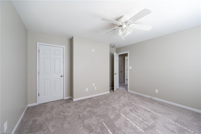 unfurnished bedroom featuring carpet flooring, ceiling fan, and baseboards