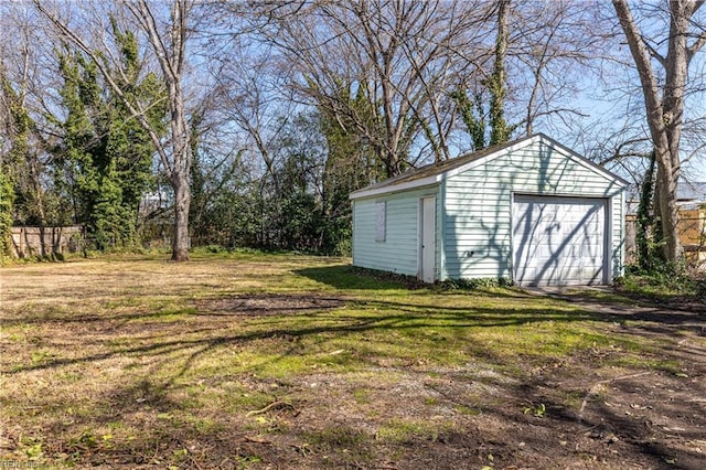 view of yard featuring an outbuilding and a detached garage