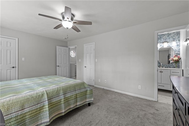 carpeted bedroom featuring connected bathroom, a ceiling fan, and baseboards