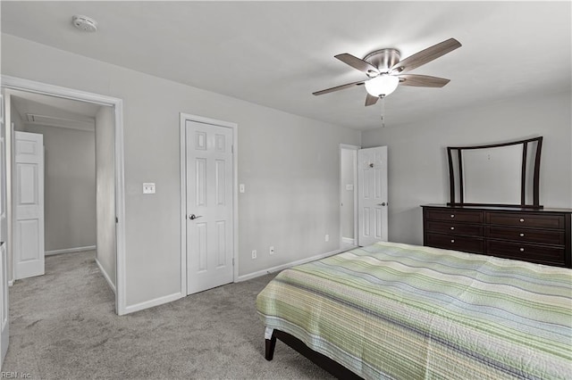 carpeted bedroom with ceiling fan and baseboards