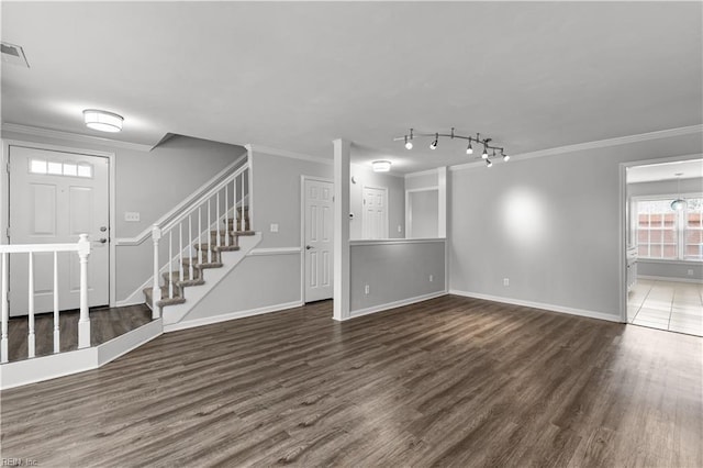 unfurnished living room featuring visible vents, ornamental molding, wood finished floors, baseboards, and stairs