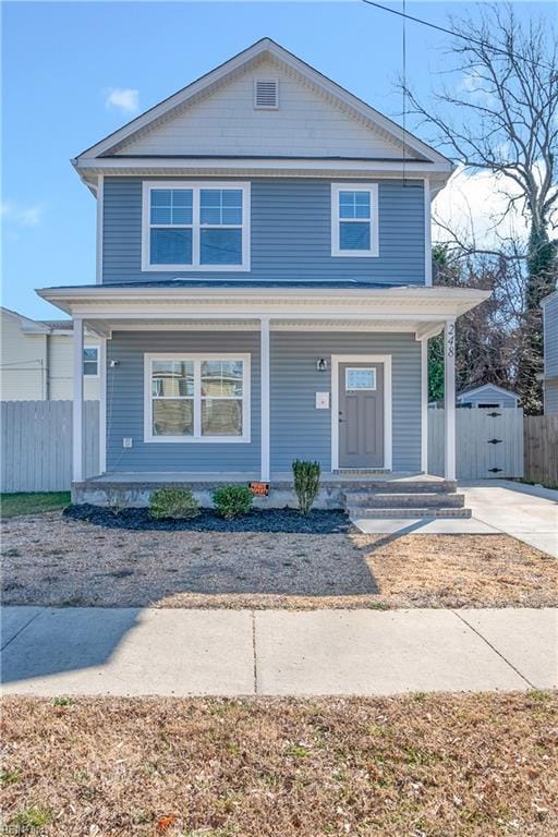 view of front of home featuring a porch and fence