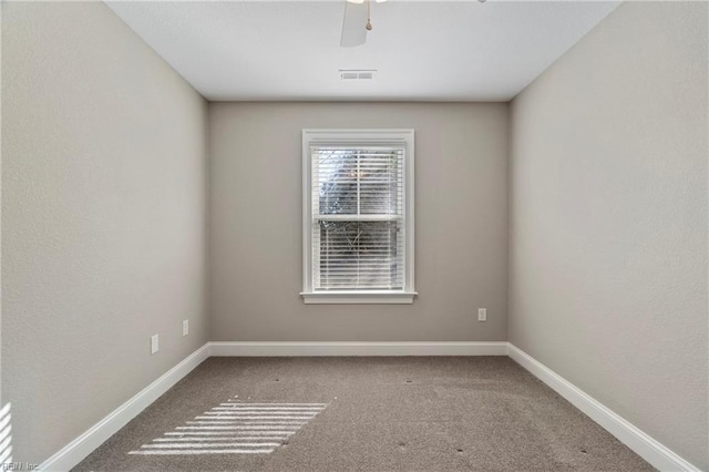 unfurnished room with ceiling fan, carpet, visible vents, and baseboards