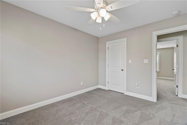 unfurnished bedroom with ceiling fan, carpet floors, and baseboards