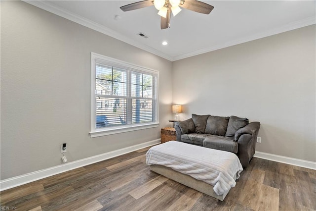 sitting room featuring ornamental molding, visible vents, baseboards, and wood finished floors