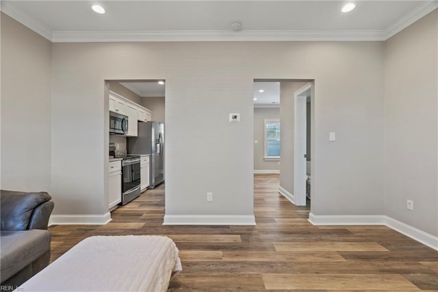 bedroom featuring baseboards, dark wood-type flooring, recessed lighting, and crown molding