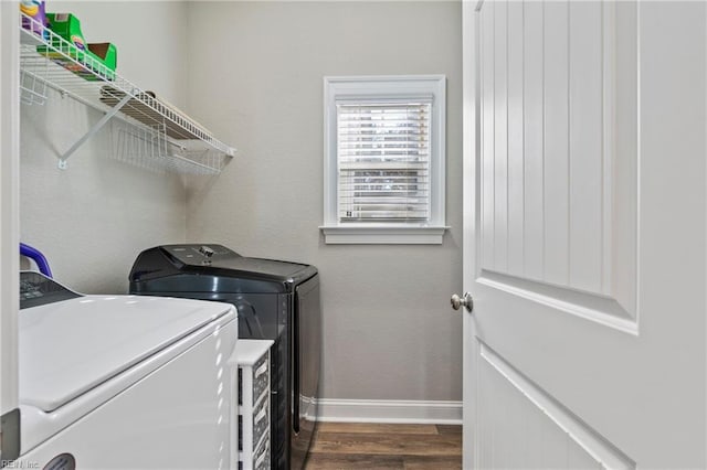 laundry room with dark wood-style floors, laundry area, separate washer and dryer, and baseboards