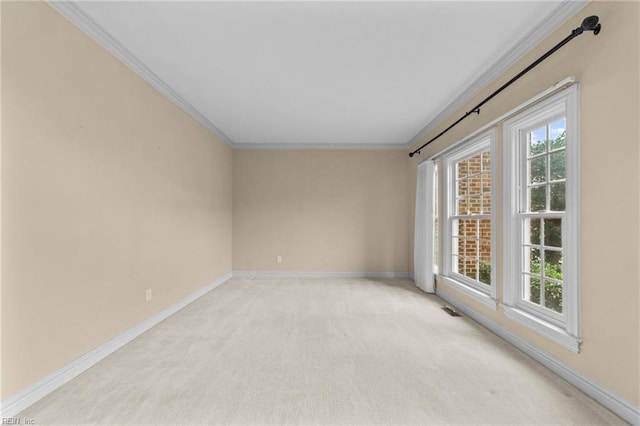 spare room featuring light carpet, baseboards, visible vents, and ornamental molding