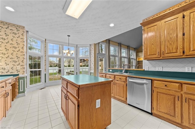 kitchen with a notable chandelier, a kitchen island, stainless steel dishwasher, decorative backsplash, and brown cabinetry