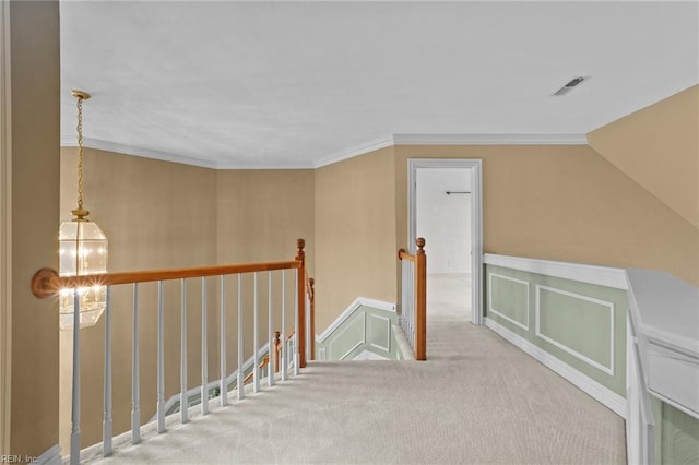 bonus room featuring carpet floors, an inviting chandelier, and a decorative wall