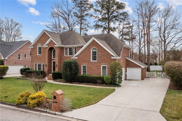 view of front of property with fence, a front lawn, concrete driveway, and brick siding