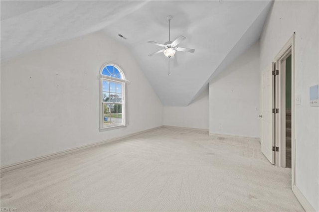 additional living space with baseboards, visible vents, ceiling fan, vaulted ceiling, and carpet flooring