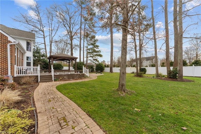 view of yard with a fenced backyard, a deck, and a gazebo