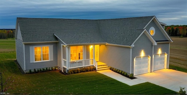 view of front facade featuring an attached garage, driveway, roof with shingles, and a front yard