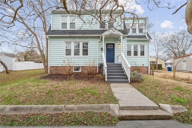 view of front of home with a shingled roof and fence