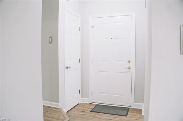 entryway featuring light wood-style flooring and baseboards