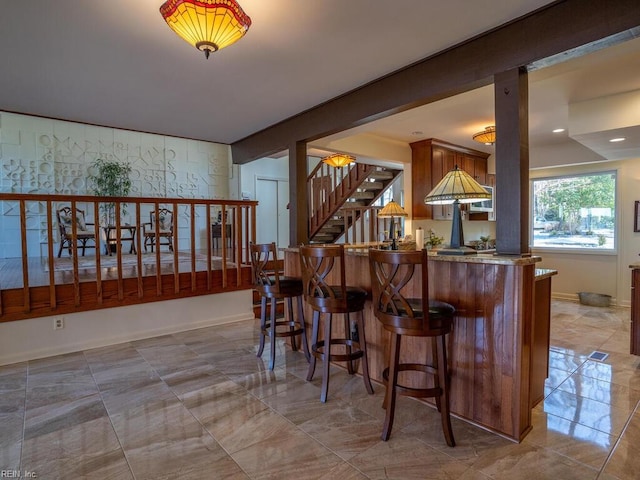 bar with marble finish floor, stairway, and baseboards