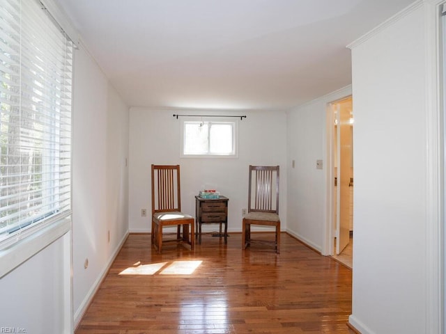 unfurnished room with light wood-style floors, ornamental molding, and baseboards