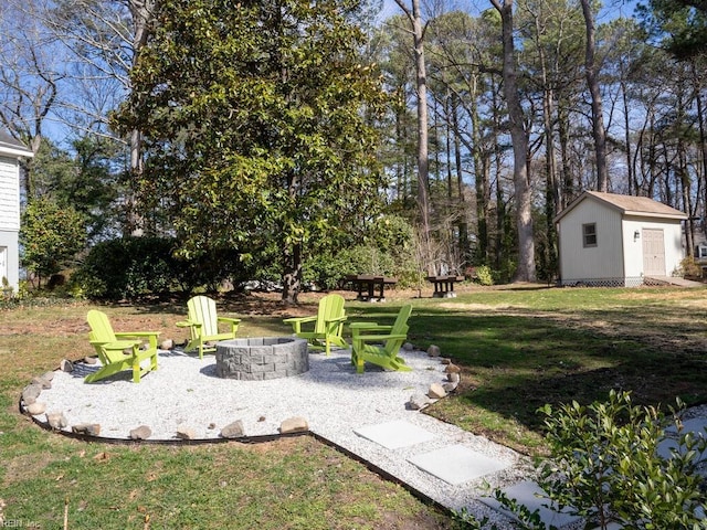 view of yard with a fire pit and an outdoor structure